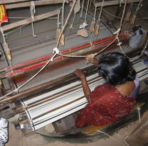 artisan weaving fair trade clothing from top view