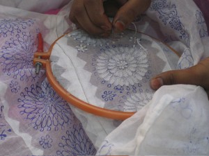 An artisan embroiders a garment in the chikankari style for Sevya's fair trade clothing collection.