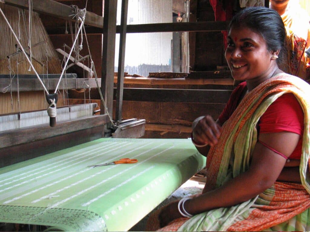 woman artisan weaving fabric in India